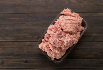 minced chicken in a tray on a wooden background