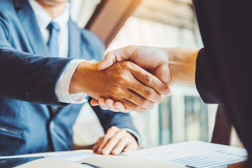 Business people colleagues shaking hands during a meeting to sign agreement for New Partner...