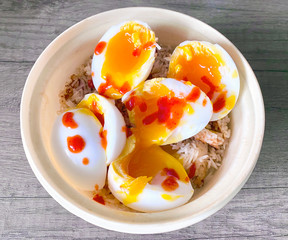 Soft boiled duck eggs on a savoury onion rice with chilli sauce a delicious snack