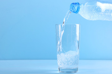 Clear water in a glass and bottle on the table