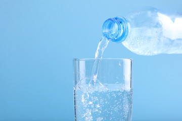 Clear water in a glass and bottle on the table