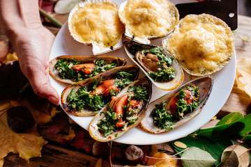 Mussels and scallops on wooden table