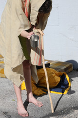 lame homeless man with a stick to walk the filthy blanket
