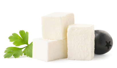 Cubes of feta cheese with a leaf and an olive close-up on a white. Isolated
