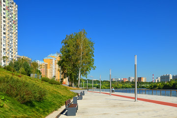 Naklejka premium Embankment and new modern residential district of Pavshinsky floodplain on Moscow River bank in summer sunny day