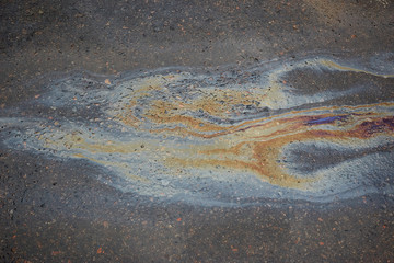 Oil stain on Asphalt, color Gasoline fuel spots on Asphalt Road as Texture or Background