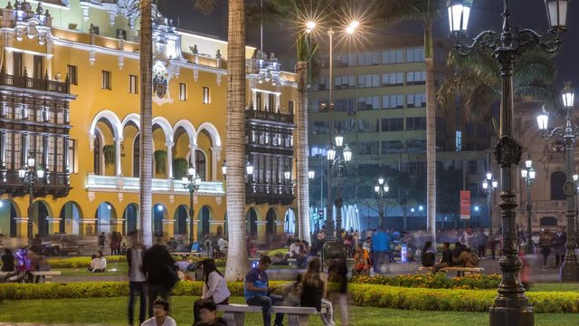 The Plaza de Armas with fountain night timelapse , also known as the Plaza Mayor, sits at the heart of Lima's historic center. Illuminated Municipal Art Gallery on a background