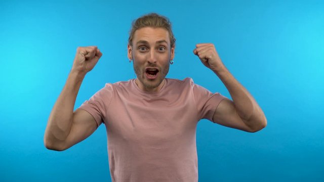 surprised shocked guy says wow. Man on an isolated blue background. 4K