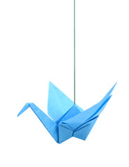 Blue origami bird hanging on white