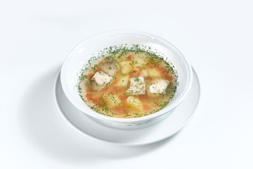 fish soup in a white plate with dill