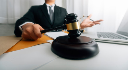 Business and lawyers discussing contract papers with brass scale on desk in office. Law, legal services, advice, justice and law concept