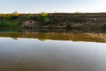 A fish pond in the countryside in the morning, the water surface is covered with fog.