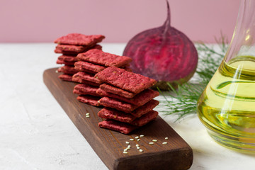 Natural crackers or beetroot cookies on a light background. Healthy food concept for wellness. Diet foods.