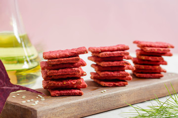 Natural crackers or beetroot cookies on a light background. Healthy food concept for wellness. Diet foods.