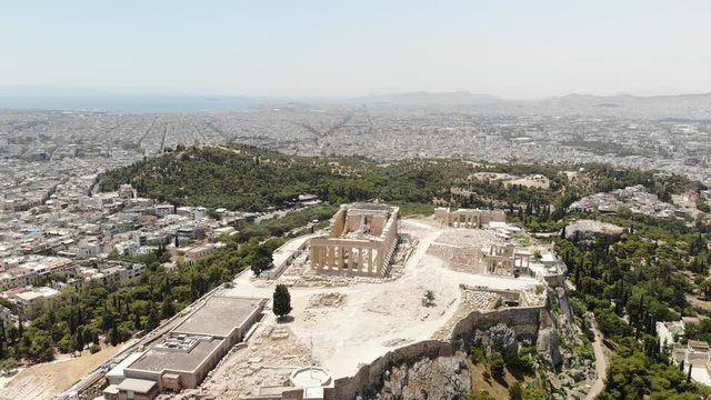 Aerial shot of the Acropolis of Athens with Filopappou Hill in the background. Summer period. Sunny day. Athens, Greece.