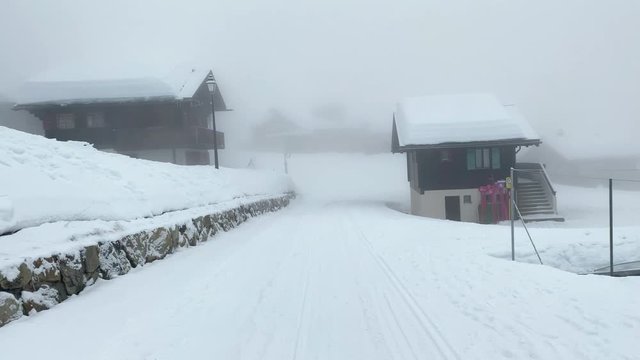 Skiing on the Bettmeralp in Switzerland in heavy fog right through the village. helmet camera