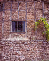 Fototapeta na wymiar grunge iron railings secured window frame and stone wall