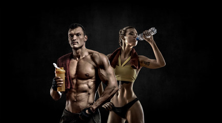 Obraz na płótnie Canvas couple man with woman bodybuilders