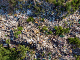 Land contamination with plastic bottles and bags. Open storage of solid waste garbage. Aerial top view