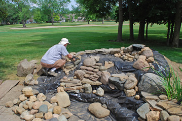 Homeowner rocking in the stream for his backyard pond/waterfall project.