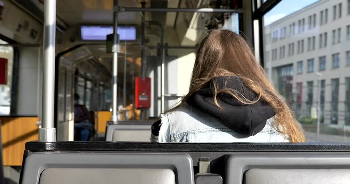 Interior and selected focus view at the back of female passenger sit in light rail tram and another passenger wear face protection mask during epidemic of COVID-19 virus with new normal concept.