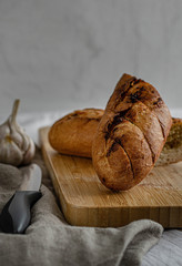Loaf of white bread with garlic on a wooden board. Sliced white bread