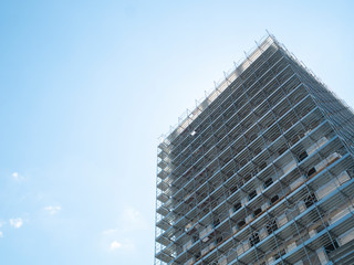 Commercial building under construction, modern skyscraper under development, new construction