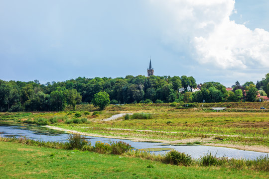 Landscape with river and church in Elsloo, Netherlands

