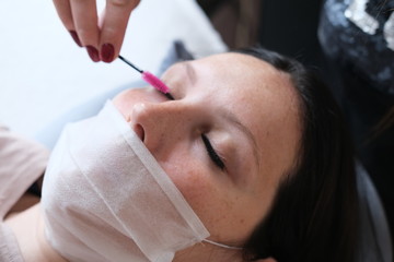 Eyelash extension close-up. Beautiful female open blue eye. Concept - Beauty services and products, fashion, makeup, cosmetics, medicine, laser surgery, vision.