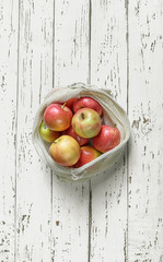 Organic fruits in reusable eco friendly natural bag on the white wooden background. Package-free food shopping. Zero waste concept and plastic free lifestyle. Top view