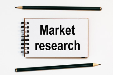 WHITE SPIRAL NOTEBOOK, TWO PENCILS WITH TEXT market research