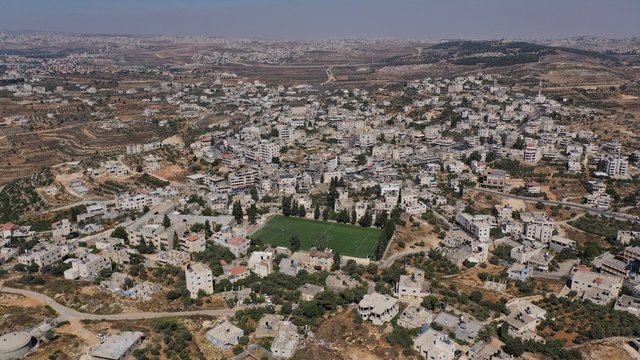 Aerial View over Palestinian Town Biddu with soccer field, Near Jerusalem 
Drone, August,2020,Israel
