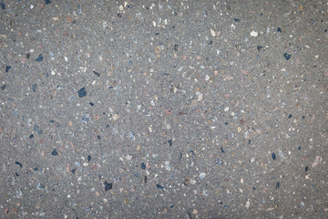 Asphalt texture with stones. Gray background.