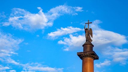 Close up of Alexander column top on Palace square background of blue sky. Unique urban landscape center St Petersburg. Central historical sights city. Tourist places in Russia. Capital Russian Empire