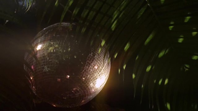Disco Ball at tropical outdoor club. Beach party theme with copy space.