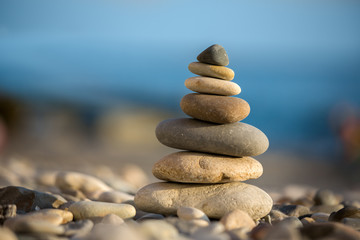 Cairn on the pebbles on sea background