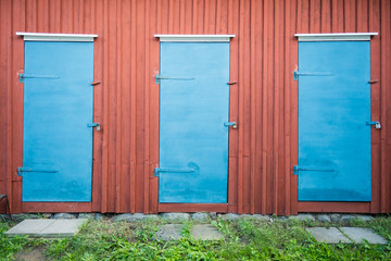 Obraz na płótnie Canvas three blue wooden doors
