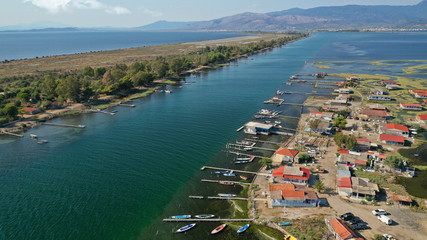 Aerial drone photo of artificial sea salt ponds in area Tourlida of Kleisova lagoon featuring seaside traditional settlement, Mesolongi, Aitoloakarnania, Greece