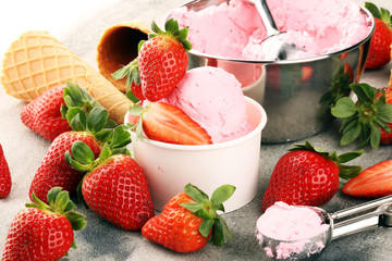 Strawberry ice cream scoop with fresh strawberries and waffle icecream cones
