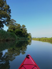 Red kayak on clear calm water