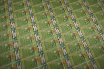 20 Canadian dollars bills printed in illegal money production conveyor. Collage of many fake bills....