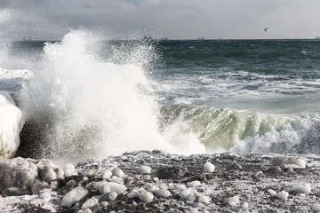 Winter seascape. Snow, ice huge waves beating against the shore and freezes. Natural disaster in form of storms and severe frosts led to icing of the black sea coast near Odessa.