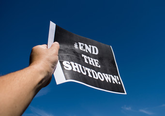 Protestors at the nation's capitol demand an end to the government shutdown. Protester holding a...