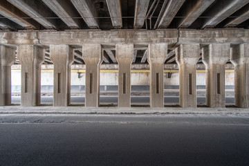 Naklejka premium A row of columns inside an old empty car tunnel.