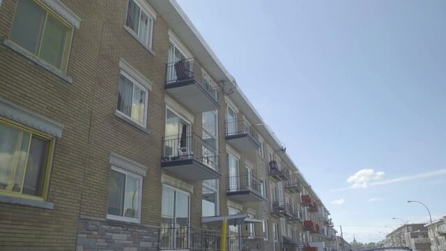 Montreal, Canada - May 1, 2018: Triplex residential apartments building in Saint Michel street, North of Montreal, Canada