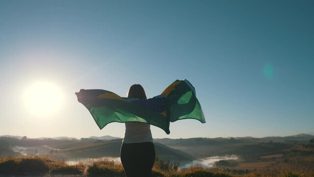 Woman walking with Brazilian flag, independence day