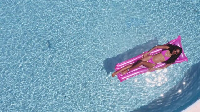Summer Sunbathing and Woman in Pink Swimsuit Floating on an Inflatable