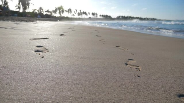 Sunset on macao beach with waves on the sea. Footprints on sandy shore. Bavaro seashore. Dominican Republic