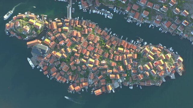 Aerial footage of densely coastal village on an island. Houses placed tight togehter.