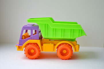 Bright colorful toy car on a white background. Isolate. Chilren play, preschool or nursery activity.